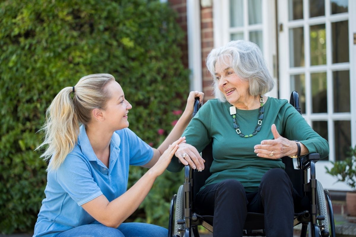 A lady is cared for at her home by a carer in her garden. Patient, care, live in care, support