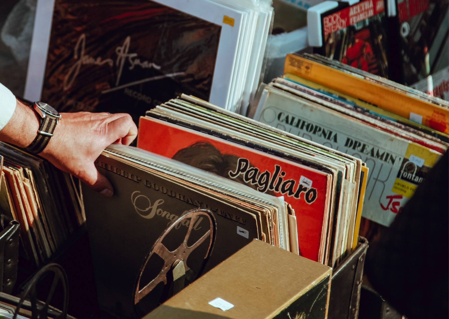 Hand looking through vinyl music records