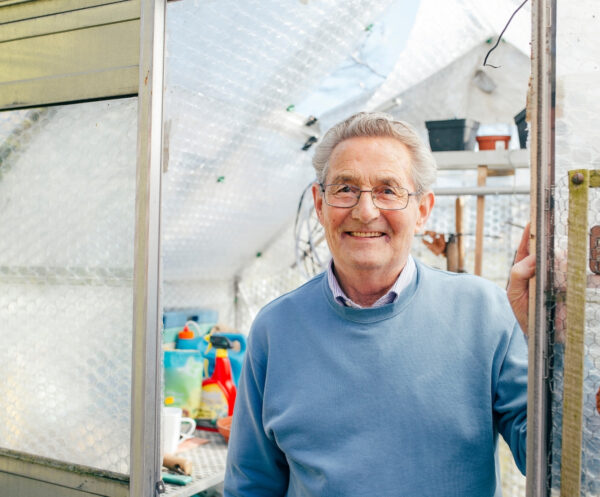 Senior person in their greenhouse