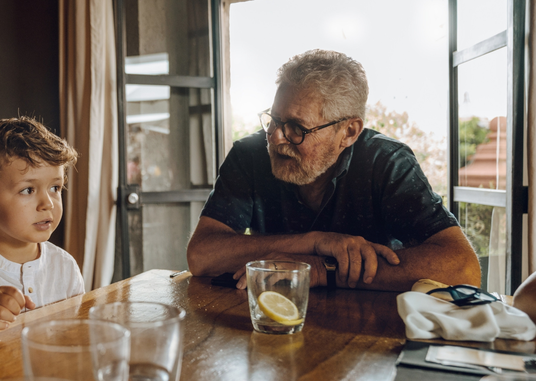 Senior man at home with grandson